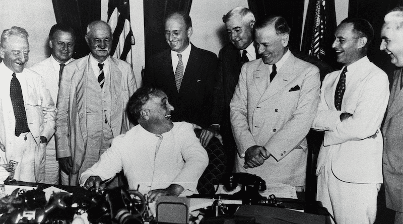 President Franklin Delano Roosevelt signs the Banking Act of 1933. Photo Credit: Federal Reserve, Wikipedia Commons
