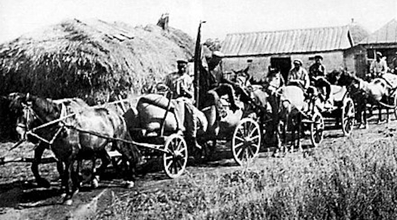 A "Red Train" of carts from the "Wave of Proletarian Revolution" collective farm in the village of Oleksiyivka, Kharkiv oblast in 1932. "Red Trains" took the first harvest of the season's crop to the government depots. During the "Holodomor", a man-made famine imposed by the Soviet Government, these brigades were part of the Government's policy of deliberately taking away the food of the peasants so as to facilitate their starvation. Photo Credit: Central State Audiovisual Archives of Ukraine, Wikipedia Commons