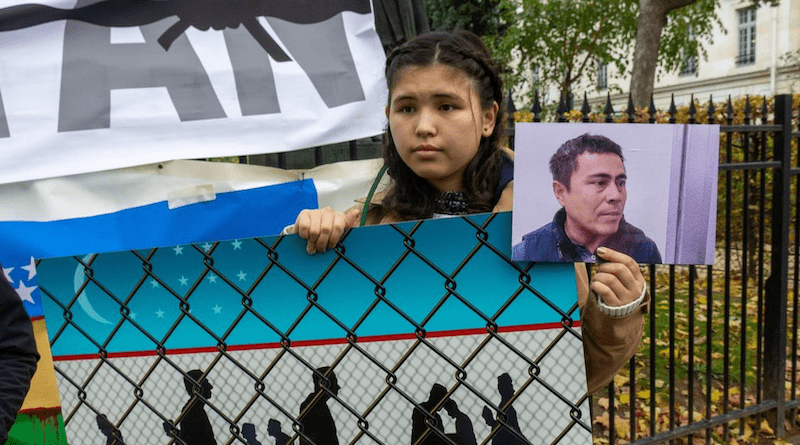 Young protester holds photo of independent blogger Otabek Sattoriy in Paris. Photo Credit: AHRCA
