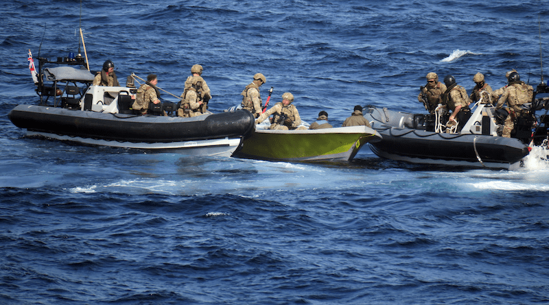 Two of HMS Lancasters sea boats flank the suspect skiff as Royal Marines retrieve the weapons cache. Photo Credit: Royal Navy