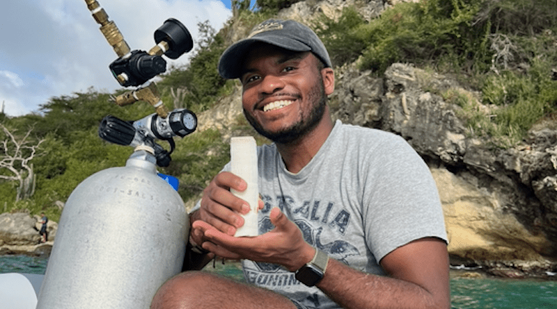 Isaiah Bolden holding a freshly collected core from a coral in Curaçao this past February. CREDIT: Georgia Tech