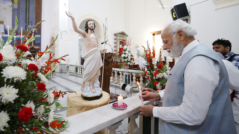 India's PM Narendra Modi lighting a candle at Delhi's Sacred Heart Cathedral Catholic Church on the occasion of Easter, in New Delhi on April 9, 2023. Photo Credit: PM India Office