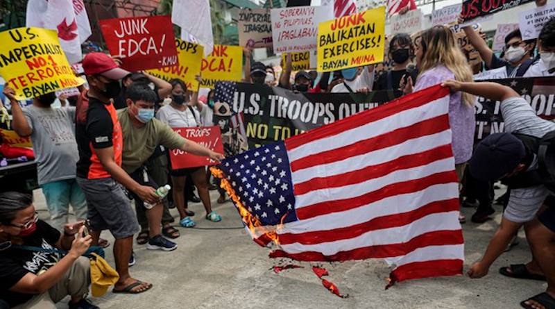 Demonstrators shout slogans and burn an American flag as they protest against the Balikatan joint military exercises, outside the headquarters of the Philippine military in Quezon City, Philippines, April 11, 2023. Phot Credit: Gerard Carreon/BenarNews