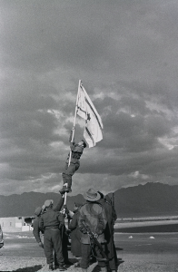 The Israeli flag is raised at Eilat at the end of the 1948 war, March 1949. Photo Credit: Micha Perry / IDF Spokesperson's Unit, Wikipedia Commons