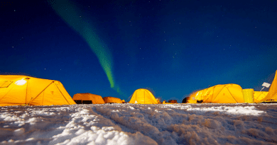 The northern lights illuminate the Arctic sky over the Navy's Ice Camp Queenfish during Ice Exercise 2022 in the Beaufort Sea in March 2022. Photo Credit: Navy Petty Officer 1st Class Cameron Stoner
