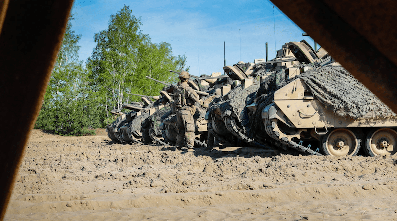 U.S. Soldiers assigned to the 1st Battalion, 8th Infantry Regiment, 3rd Armored Brigade Combat Team, 4th Infantry Division, arrive on their assigned M2A3 Bradley fighting vehicles prior to live demolition training as part of Defender 22 at Oberlausitz Training Area, Germany, May 10, 2022. Photo Credit: Army Staff Sgt. Gabriel Rivera, National Guard