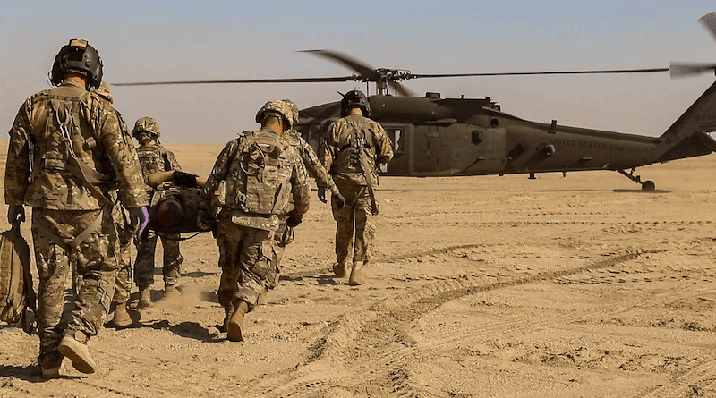 U.S. Army Soldiers assigned to the 2-211th General Support Aviation Battalion, Minnesota Army National Guard, and the 155th Armored Brigade Combat Team, Mississippi Army National Guard, carry a patient to a UH-60L Black Hawk helicopter during an aeromedical evacuation rehearsal at Udairi Range Complex near Camp Buehring, Kuwait. Photo Credit: Sgt. Emily Finn, DOD