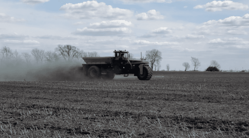 Spreading basalt rock dust with a conventional lime spreader on row crop acres in the U.S. corn belt. As the rock dust dissolves in the soil, it converts carbon dioxide to dissolved ions that are eventually transported to the ocean via runoff and stored for thousands of years. CREDIT: Gavi Welbel
