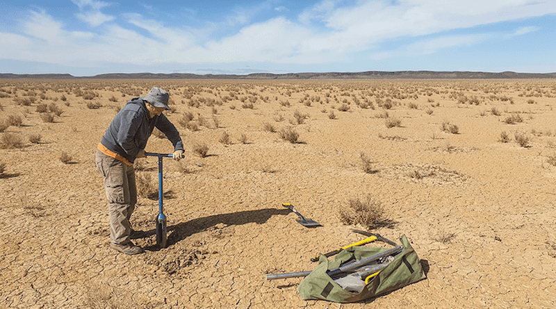 Andrew Carr collecting sediment samples dating to the Last Glacial Maximum from the dry lakebed at Swartkolkvloer. CREDIT: Brian Chase