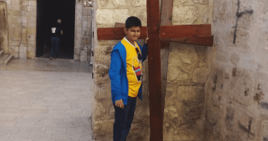 The author Apratim Acharyya standing in front of a cross on the Via Dolorosa in Jerusalem. (photo provided by family)
