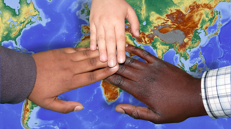 hands globe peace children migrants immigration