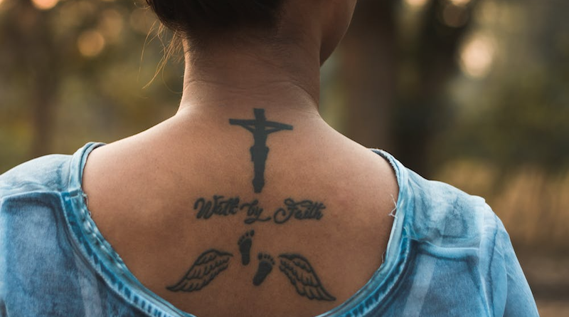 woman religion cross tattoo