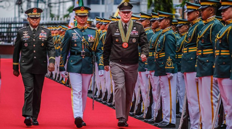 Philippine Army Chief Lt. Gen. Romeo Brawner Jr. (left) and Gen. James McConville, the U.S. Army chief of staff (center), review an honor guard at Philippine Army Headquarters in Manila, May 10, 2023. Photo Credit: Jojo Riñoza/BenarNews
