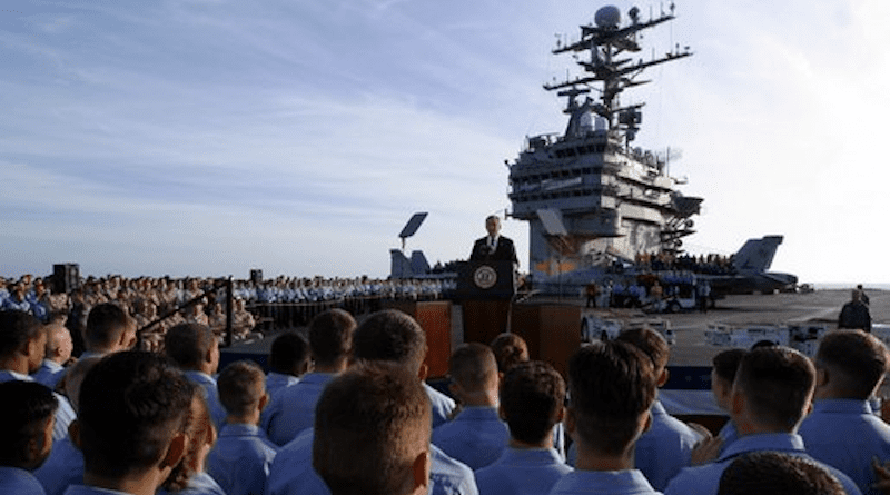 President George W. Bush addresses sailors and the nation from the flight deck of the USS Abraham Lincoln of the coast of San Diego, California May 1, 2003. White House photo by Paul Morse