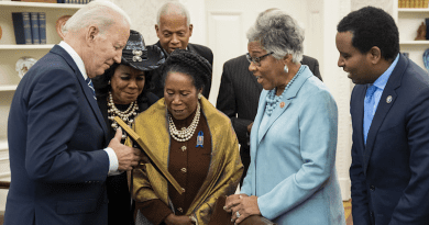 President Joe Biden shares a framed photo with members of the Congressional Black Caucus, Monday, March 7, 2022, in the Oval Office. (Official White House Photo by Adam Schultz)