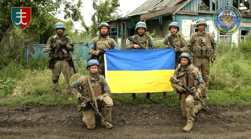 Ukrainian soldiers fly flag at reclaimed Storozheve. Photo Credit: Ukraine's ArmyInform