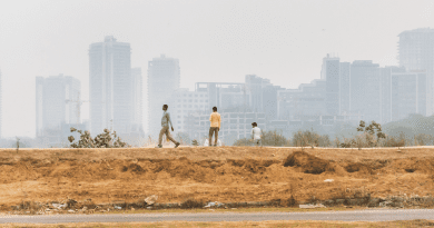 Photo by Gaia Squarci. Men walk on a peripheral street of Gurgaon, a fast-expanding technology hub on the outskirts of Delhi, known for having one of the worst air quality indexes on the planet. India, 2019 - Humidity 75%, Temperature 21°C