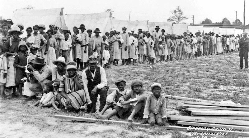 Refugees stand in line at Birdsong Camp, Cleveland, Mississippi, after the The Great Mississippi Flood of 1927. Photo Credit: Mississippi Department of Archives
