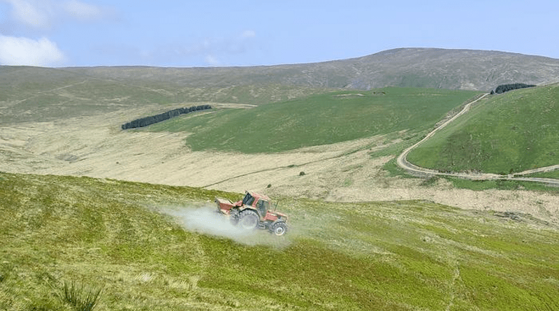 A tractor spreads rock dust on upland grassland in Plylimon, mid-Wales. CREDIT: Alan Radbourne, UKCEH