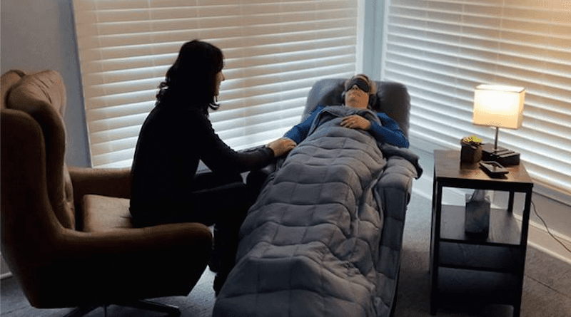 Medical University of South Carolina psychiatrist Dr. Jennifer Jones (left) and Melissa Michel (right, reclining), lead therapist for MUSC's Centerspace clinic, demonstrating psychedelic-assisted therapy. CREDIT: Medical University of South Carolina. Photograph courtesy of Dr. Jennifer Jones.