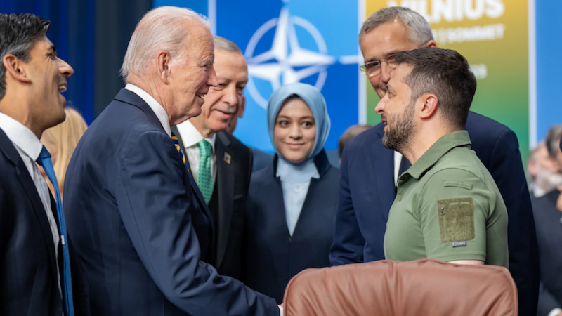 U.S. President Joe Biden greets Ukrainian President Volodymyr Zelensky as NATO Secretary General Jens Stoltenberg looks on at the alliance’s Vilnius Summit, July 12, 2023 in Lithuania. Photo Credit: DOD