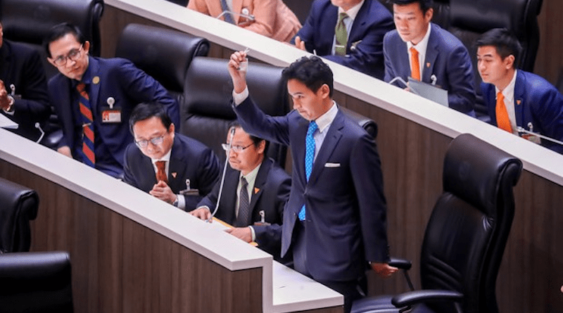 Pita Limjaroenrat, the Move Forward Party’s candidate for prime minister, removes his lawmaker’s badge in Parliament in Bangkok after Thailand’s Constitutional Court suspended him as an MP, July 19, 2023. Photo Credit: Nava Sangthong/BenarNews