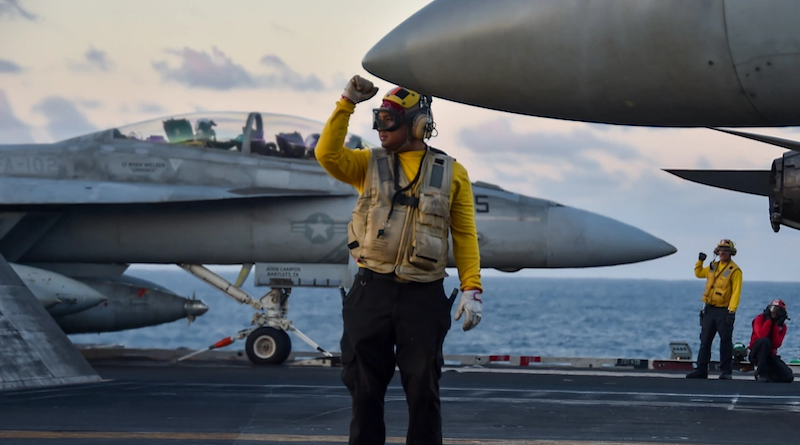 Aviation Boatswain’s Mate (Aircraft Handling) 1st Class Michael Angelo Smith, from Cebu, Philippines, directs aircraft on the flight deck aboard the U.S. Navy’s only forward-deployed aircraft carrier, USS Ronald Reagan (CVN 76), in the Indian Ocean, July 19, 2023. Ronald Reagan, the flagship of Carrier Strike Group 5, provides a combat-ready force that protects and defends the United States, and supports alliances, partnerships and collective maritime interests in the Indo-Pacific region. (U.S. Navy photo by Mass Communication Specialist 3rd Class Natasha ChevalierLosada)