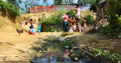 Refugees collect water from a well next to a dirty drain in the Shalbon Rohingya camp in Teknaf, Bangladesh. Photo Credit: Abdur Rahman/BenarNews