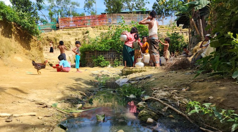 Refugees collect water from a well next to a dirty drain in the Shalbon Rohingya camp in Teknaf, Bangladesh. Photo Credit: Abdur Rahman/BenarNews