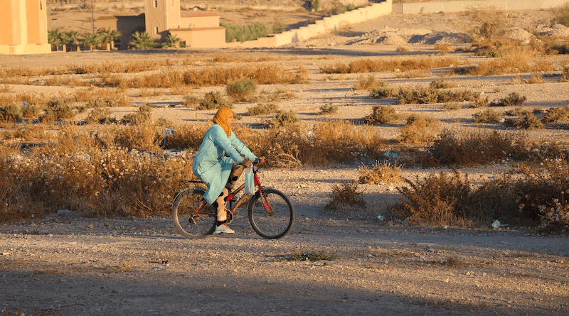woman desert Morocco bicycle