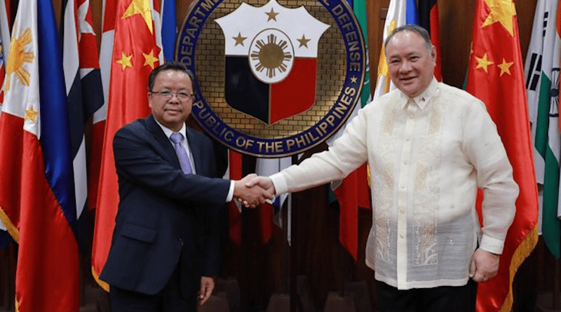 Philippine Defense Secretary Gilberto Teodoro Jr. shakes hands with Chinese Ambassador Huang Xilian before a closed-door meeting in Manila, July 6, 2023. [Handout photo/Philippine Department of National Defense]
