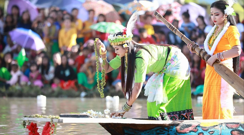 A Meitei woman holding a garland of gooseberries to participate in the Heikru Hidongba in Manipur, India. Photo Credit: Awangba Mangang, Wikipedia Commons