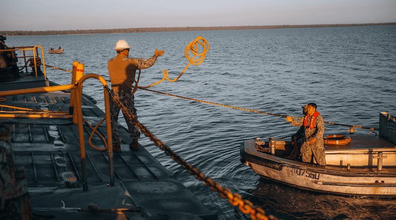 Navy Chief Petty Officer Jason Langley tosses a line to Navy Lt. Dylan Christianson from the Australian commercial vessel Bandicoot during Exercise Talisman Sabre 23 in Weipa, Australia, July 21, 2023. Langley and Christianson are with Amphibious Construction Battalion 1. Photo Credit: DOD
