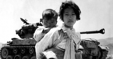 A young Korean girl carries her brother past a stalled M-46 tank, at Haengju, Korea. Photo Credit: Maj. R.V. Spencer, UAF (Navy). U.S. Army Korea, Wikimedia Commons