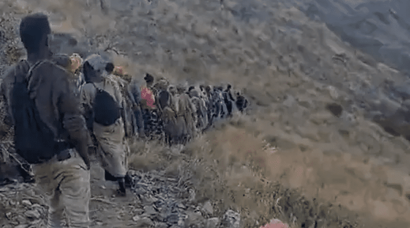 Screenshot of a video published on TikTok on December 4, 2022 shows a group of roughly 47 migrants, 37 of whom appear to be women, walking along a steep slope inside Saudi Arabia on the trail used to cross from the migrant camp of Al Thabit. Photo Credit: Human Rights Watch