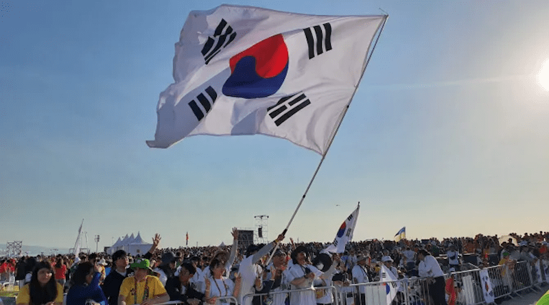 Pilgrims from South Korea wave a flag at Mass with Pope Francis for the closing of World Youth Day 2023 in Lisbon on Aug. 6, 2023. | Hannah Brockhaus/CNA