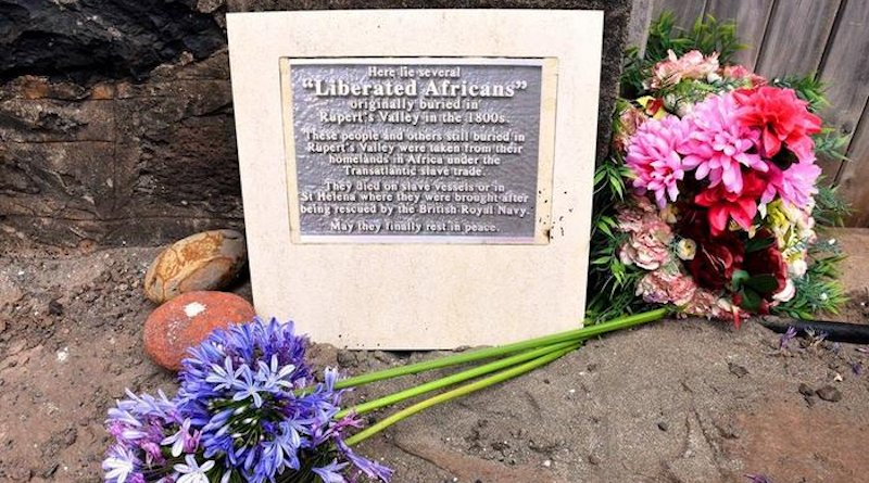 A plaque dedicated to "Liberated Africans" in St. Helena with flowers around it. CREDIT: St Helena Government
