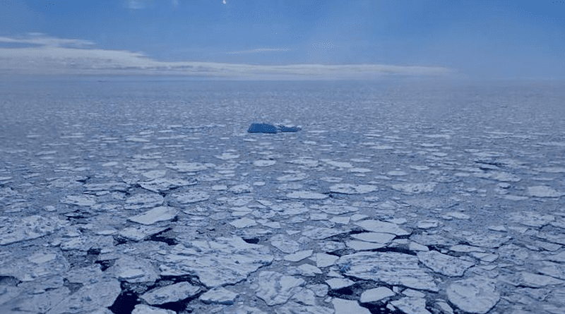 A lone iceberg amidst sea ice along the coast east of Sermilik Fjord. Photo taken during an Operation IceBridge flight on Apr. 27, 2018. Credits: NASA/Joe MacGregor