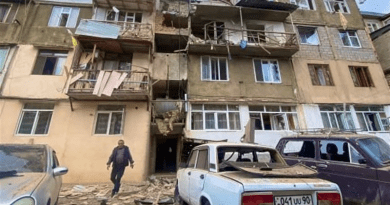 A man leaves a bombed apartment building in Nagorno-Karabakh. Photo Credit: Tasnim News Agency