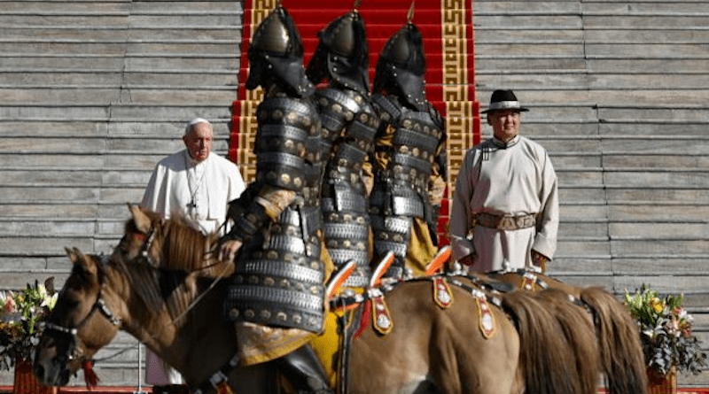 Pope Francis stands beside Mongolian President Ukhnaagiin Khürelsükh as a traditional parade on horseback welcomes the pope in Sukhbaatar Square. Vatican Media