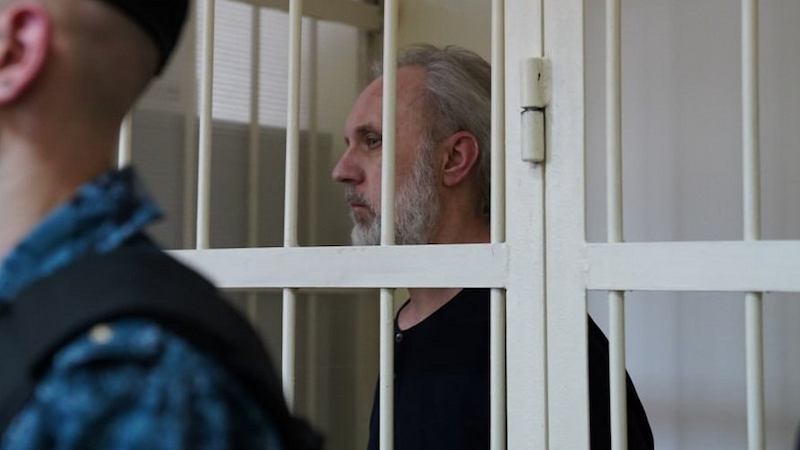Fr Ioann Kurmoyarov in the defendant's cage, Kalinin District Court, St Petersburg Photo Credit: RFE/RL