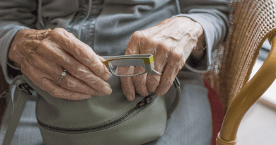 elderly woman glasses hands