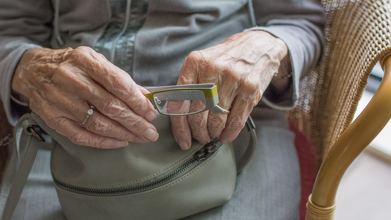elderly woman glasses hands