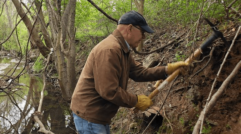 Dan Richter, a professor of soils at Duke University’s Nicholas School of the Environment, samples the edges of a creek bed on the site of a former municipal waste incinerator in Durham, NC. CREDIT: Dan Richter, Duke University