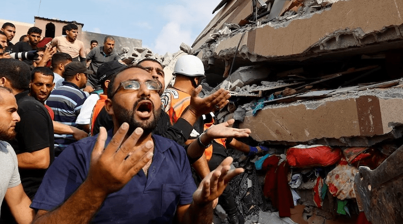 Palestinians near the site of an airstrike. Photo Credit: Fars News Agency