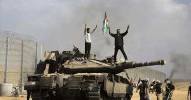 Palestinians on destroyed Israeli tank. Photo Credit: Mehr News Agency