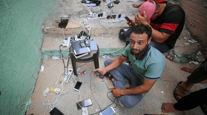 Gazans charge their mobile phones from points powered by solar panels. Copyright: SciDev.Net
