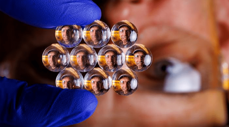 The visage of Stephen Morin, associate professor of chemistry, refracts through an array of lenses. Morin and his Nebraska colleagues have crafted much smaller lenses — some of them substantially narrower than a human hair — whose size and optical properties can be modified in seconds when subjected to certain stimuli. CREDIT: Craig Chandler, University of Nebraska–Lincoln