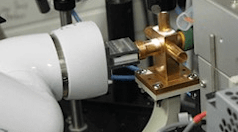 Picture of an operating robot performing a microwave conductivity measurement. Photo Credit: Akinori Saeki