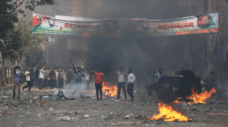 Bangladesh Nationalist Party activists, some armed with sticks, hold their ground against police after violence broke out during their protest rally in Dhaka, Oct. 28, 2023. Photo Credit: BenarNews